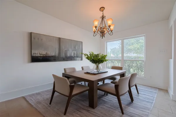 a view of a dining room with furniture wooden floor and a chandelier