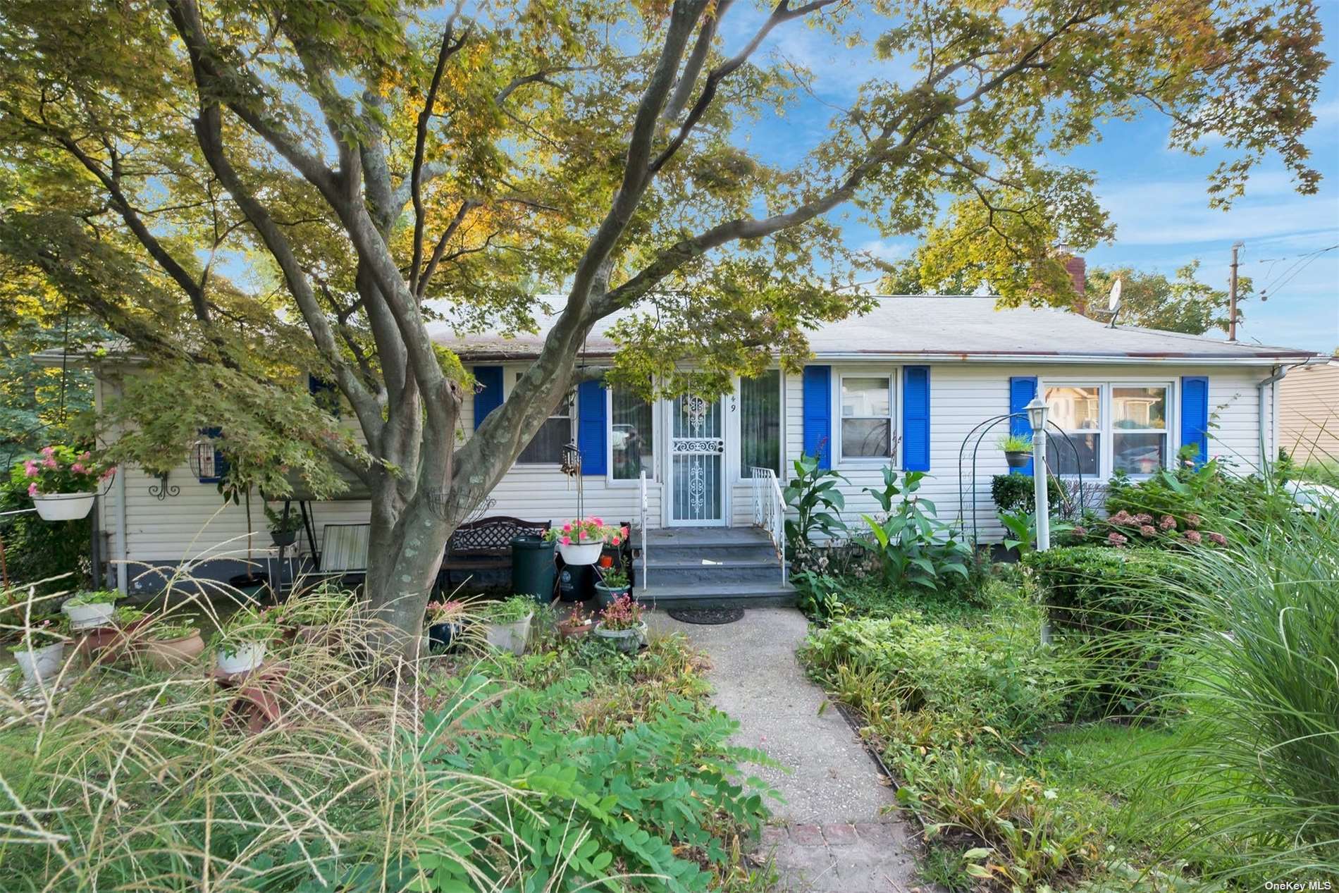 a front view of a house with a garden
