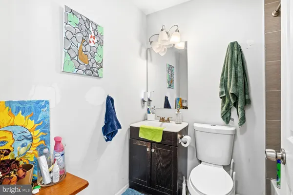 a bathroom with a toilet sink and mirror