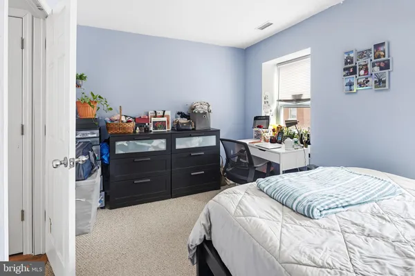 a bed room with a bed and a dresser