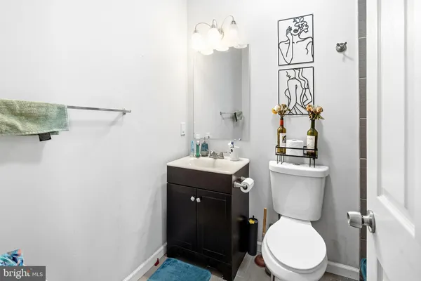 a bathroom with a toilet a sink and mirror