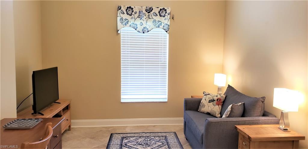 2258 Stacil Circle, Unit 1 Naples, FL 34109 - Photo 15 of 28 a living room with furniture and a flat screen tv