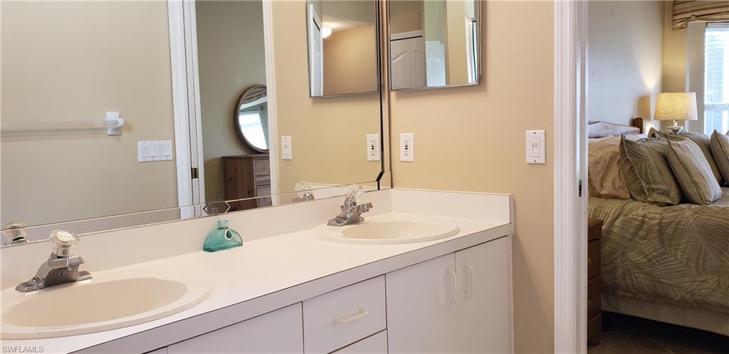 2258 Stacil Circle, Unit 1 Naples, FL 34109 - Photo 19 of 28 a bathroom with a sink and a mirror