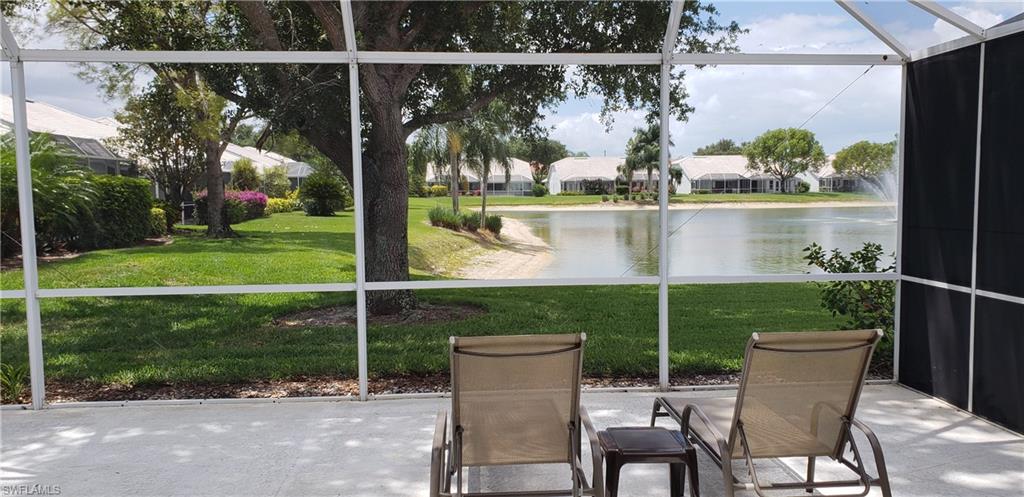 2258 Stacil Circle, Unit 1 Naples, FL 34109 - Photo 20 of 28 a view of a chair and tables in the patio