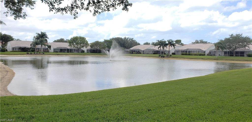 2258 Stacil Circle, Unit 1 Naples, FL 34109 - Photo 22 of 28 a view of a lake with houses in the back