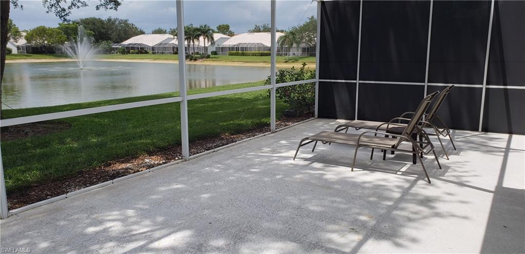 2258 Stacil Circle, Unit 1 Naples, FL 34109 - Photo 23 of 28 a backyard of a house with table and chairs potted plants