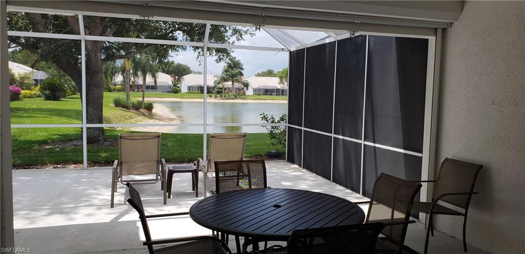 2258 Stacil Circle, Unit 1 Naples, FL 34109 - Photo 24 of 28 a balcony with table and chairs