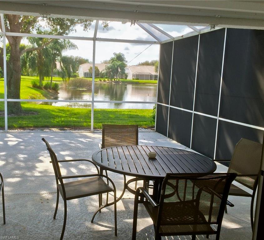 2258 Stacil Circle, Unit 1 Naples, FL 34109 - Photo 25 of 28 a view of a patio with a table chairs and a backyard