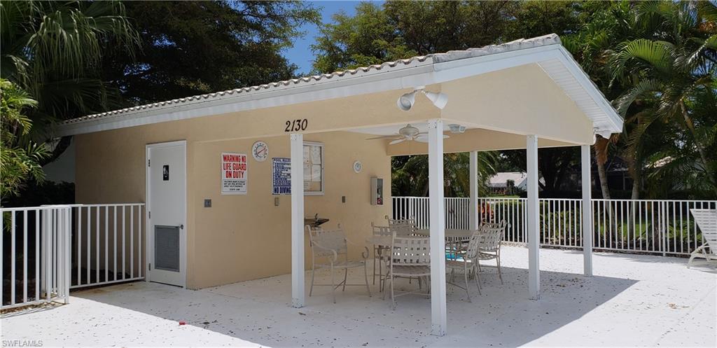 2258 Stacil Circle, Unit 1 Naples, FL 34109 - Photo 28 of 28 a terrace with outdoor seating and yard