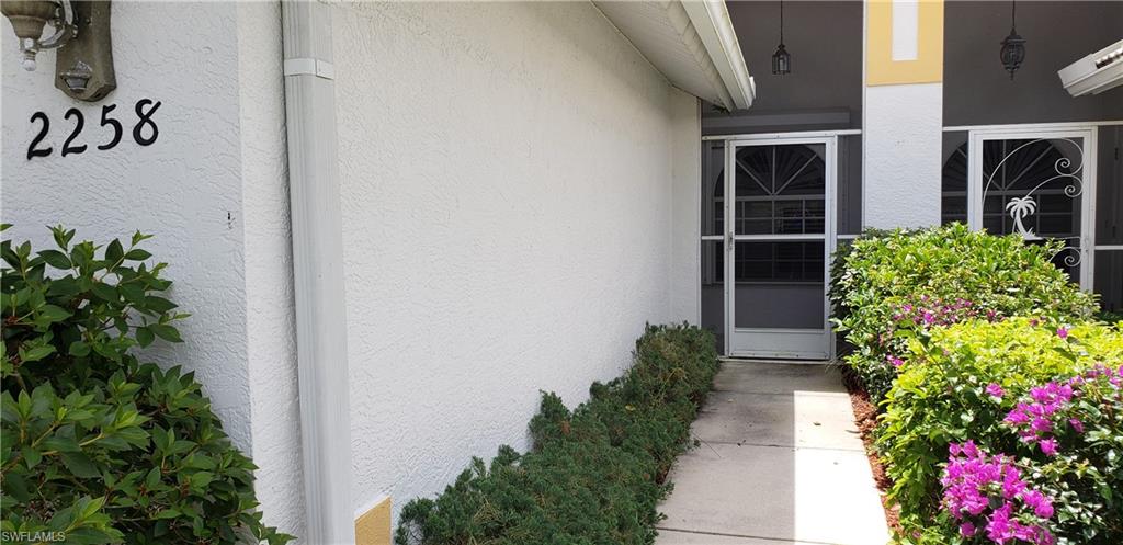 2258 Stacil Circle, Unit 1 Naples, FL 34109 - Photo 3 of 28 a view of a house with potted plants