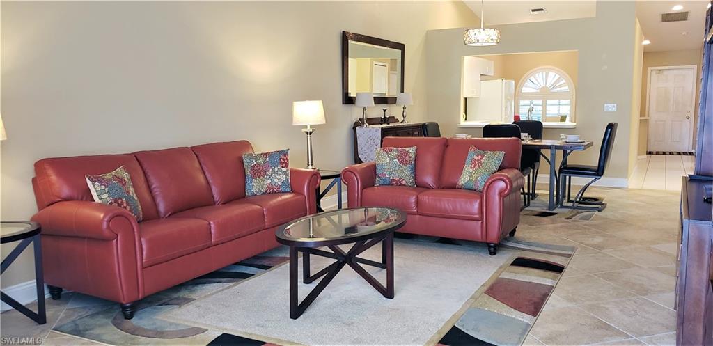 2258 Stacil Circle, Unit 1 Naples, FL 34109 - Photo 4 of 28 a living room with furniture and a chandelier