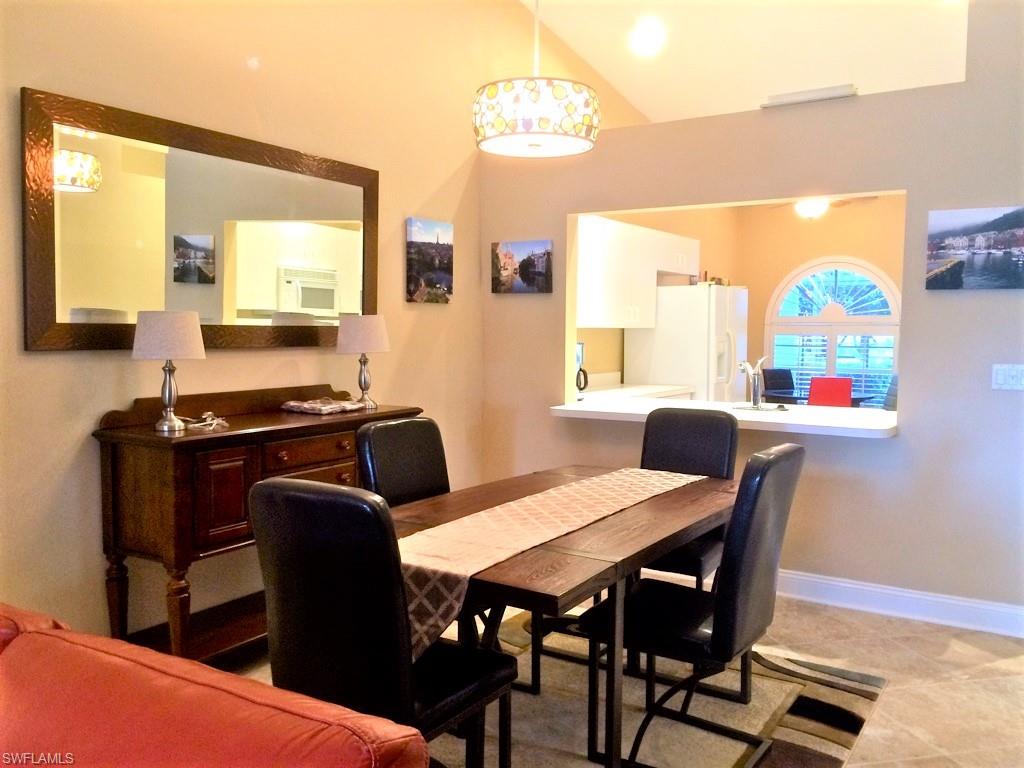 2258 Stacil Circle, Unit 1 Naples, FL 34109 - Photo 8 of 28 a view of a dining room with furniture and a window