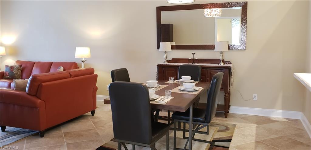 2258 Stacil Circle, Unit 1 Naples, FL 34109 - Photo 9 of 28 a view of a dining room with furniture and wooden floor