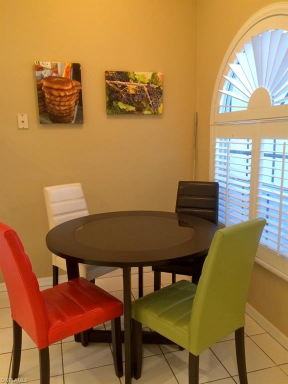 2258 Stacil Circle, Unit 1 Naples, FL 34109 - Photo 10 of 28 a view of a dining room with furniture and a window