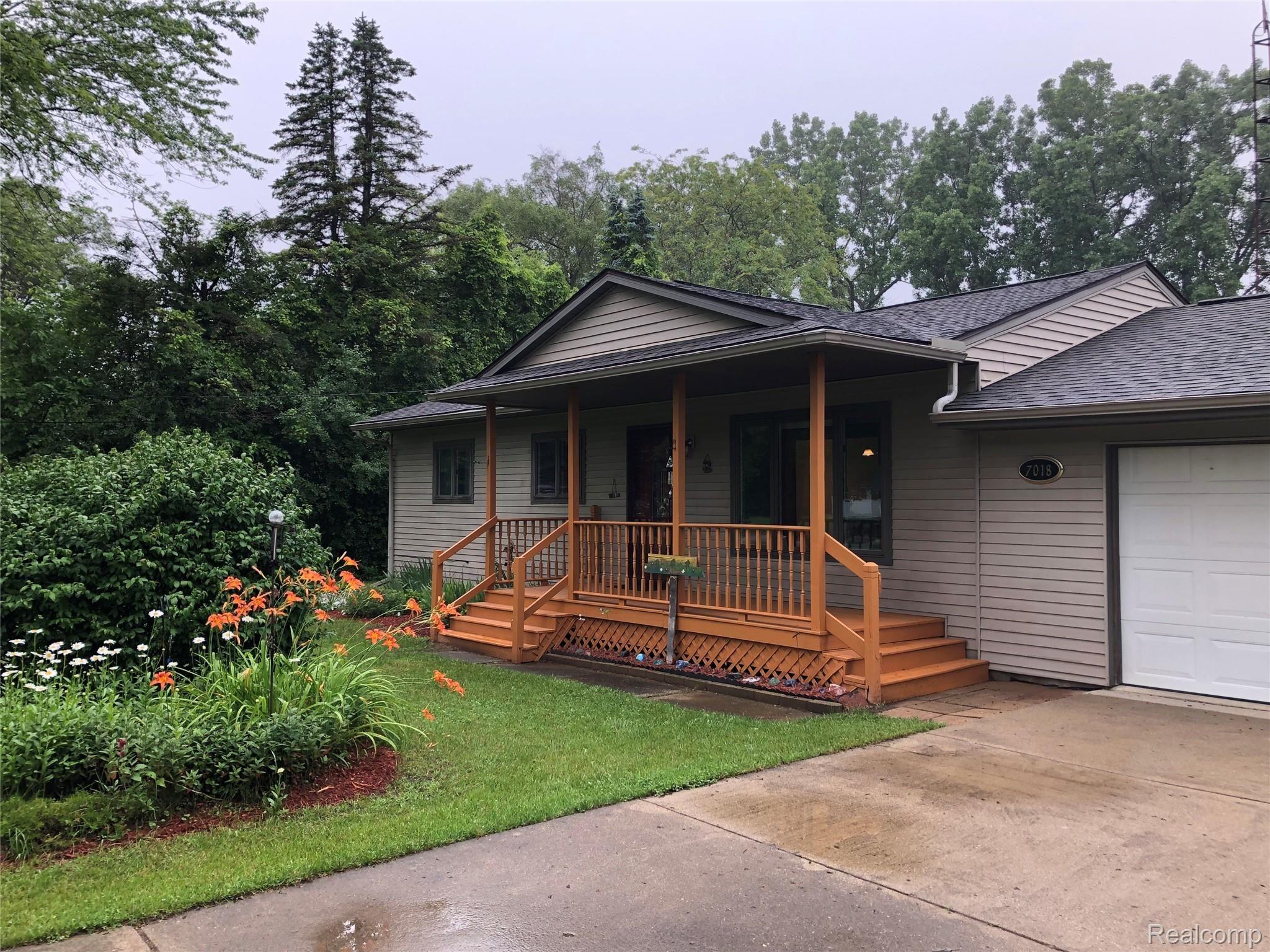 7018 Wilson Road Montrose, MI 48457 - Photo 1 of 24 Front of home features a newly painted covered porch