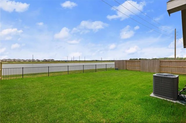 a view of a green field with wooden fence
