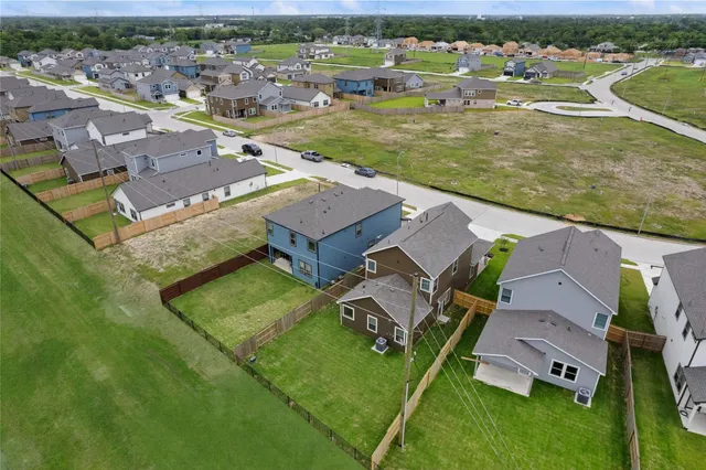 an aerial view of residential houses with outdoor space
