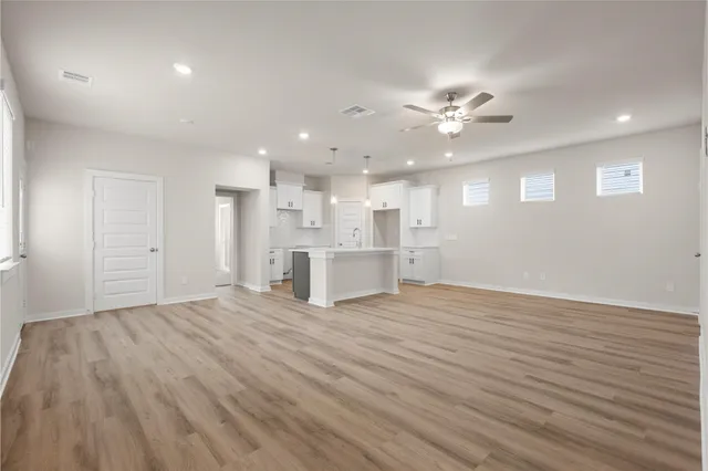 a view of an empty room with a kitchen