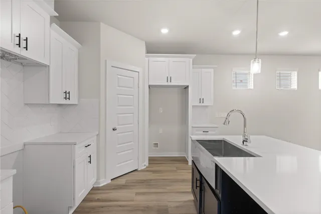 a kitchen with kitchen island a sink stainless steel appliances and cabinets