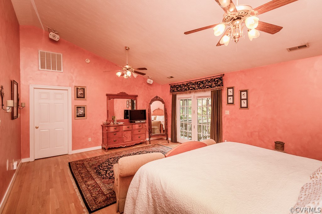 8485 Stumpy Road Hanover, VA 23069 - Photo 17 of 50 a bedroom with a large bed and a chandelier