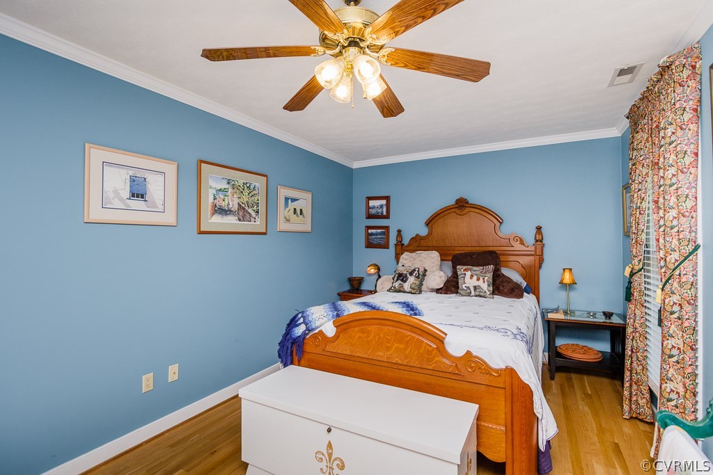 8485 Stumpy Road Hanover, VA 23069 - Photo 20 of 50 a bedroom with a bed and a chandelier