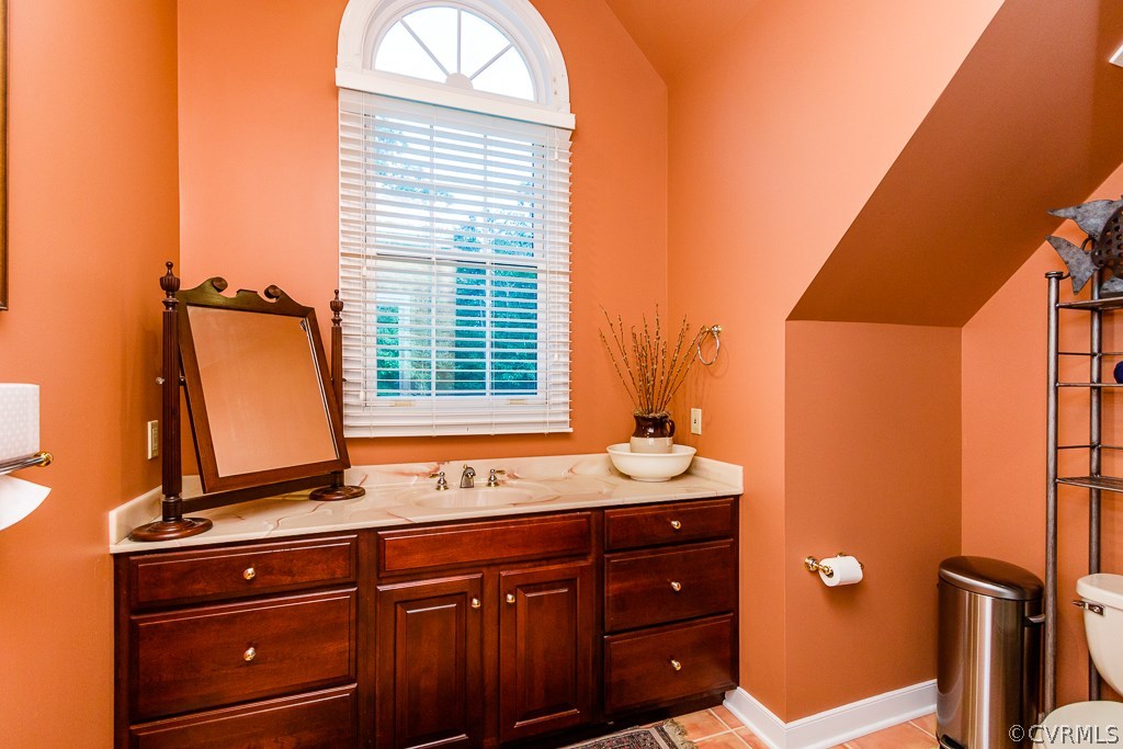 8485 Stumpy Road Hanover, VA 23069 - Photo 29 of 50 a bathroom with a sink a mirror and a window