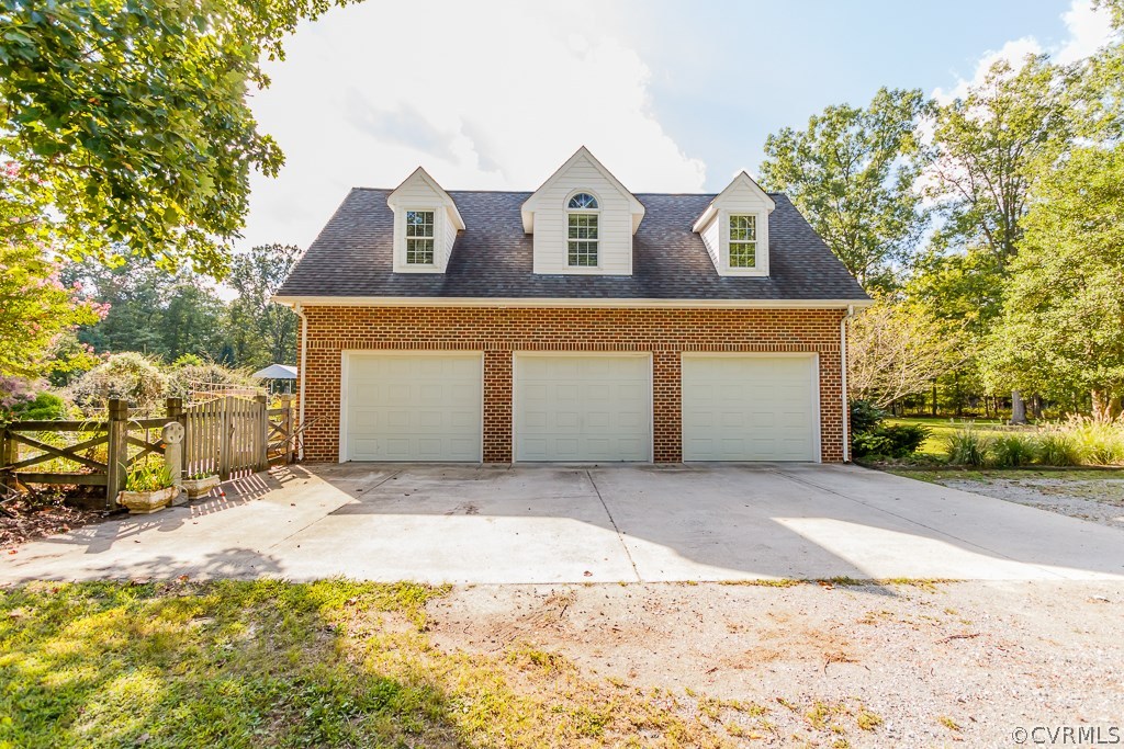 8485 Stumpy Road Hanover, VA 23069 - Photo 3 of 50 a front view of a house with a yard and garage