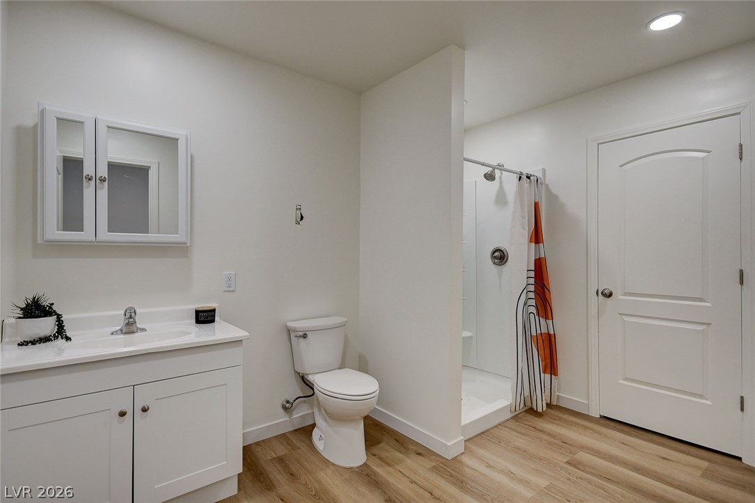 1920 Bowman Road Logandale, NV 89021 - Photo 55 of 68 Clean lines and warm wood-look flooring define this streamlined modern bathroom design.