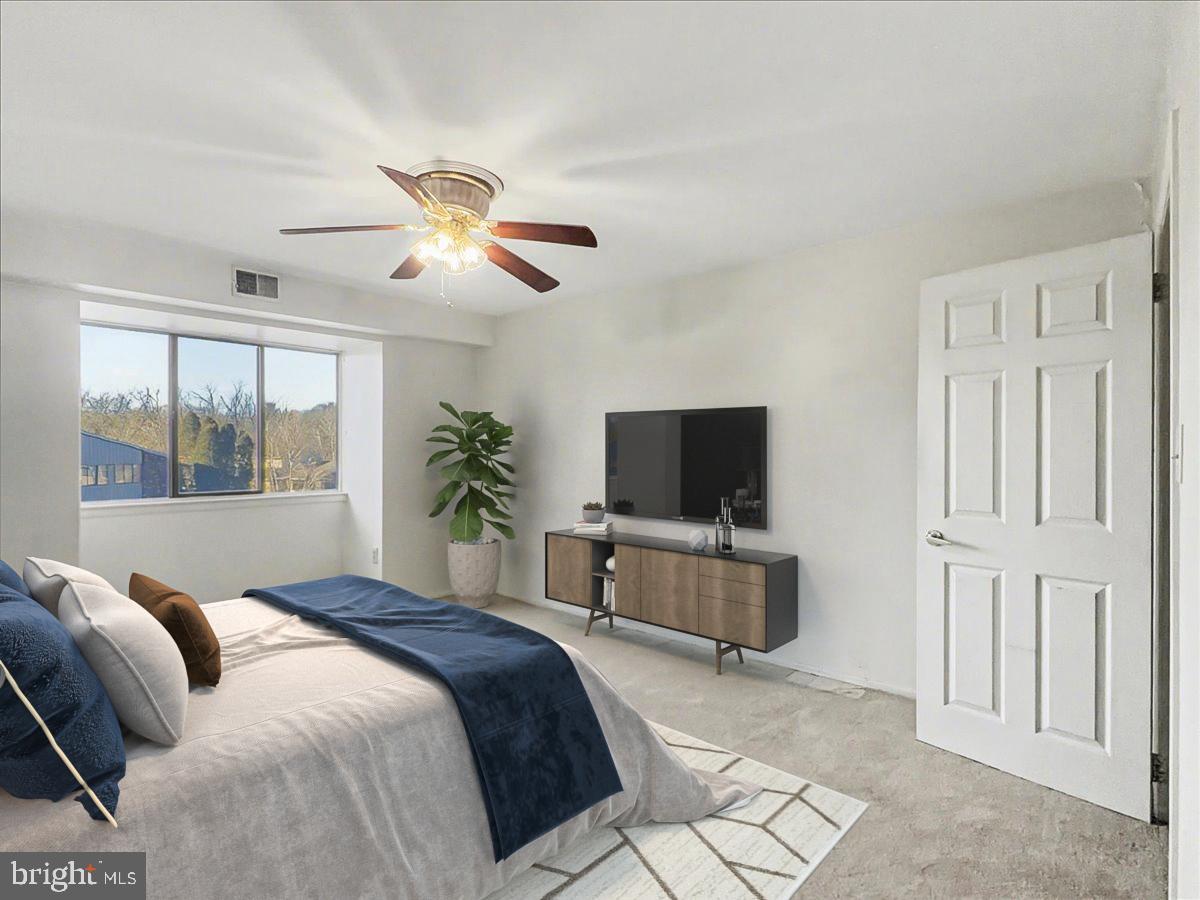 1575 Creekside Road, Unit A21 Whitehall, PA 18052 - Photo 5 of 21 a bedroom with a bed and a flat screen tv