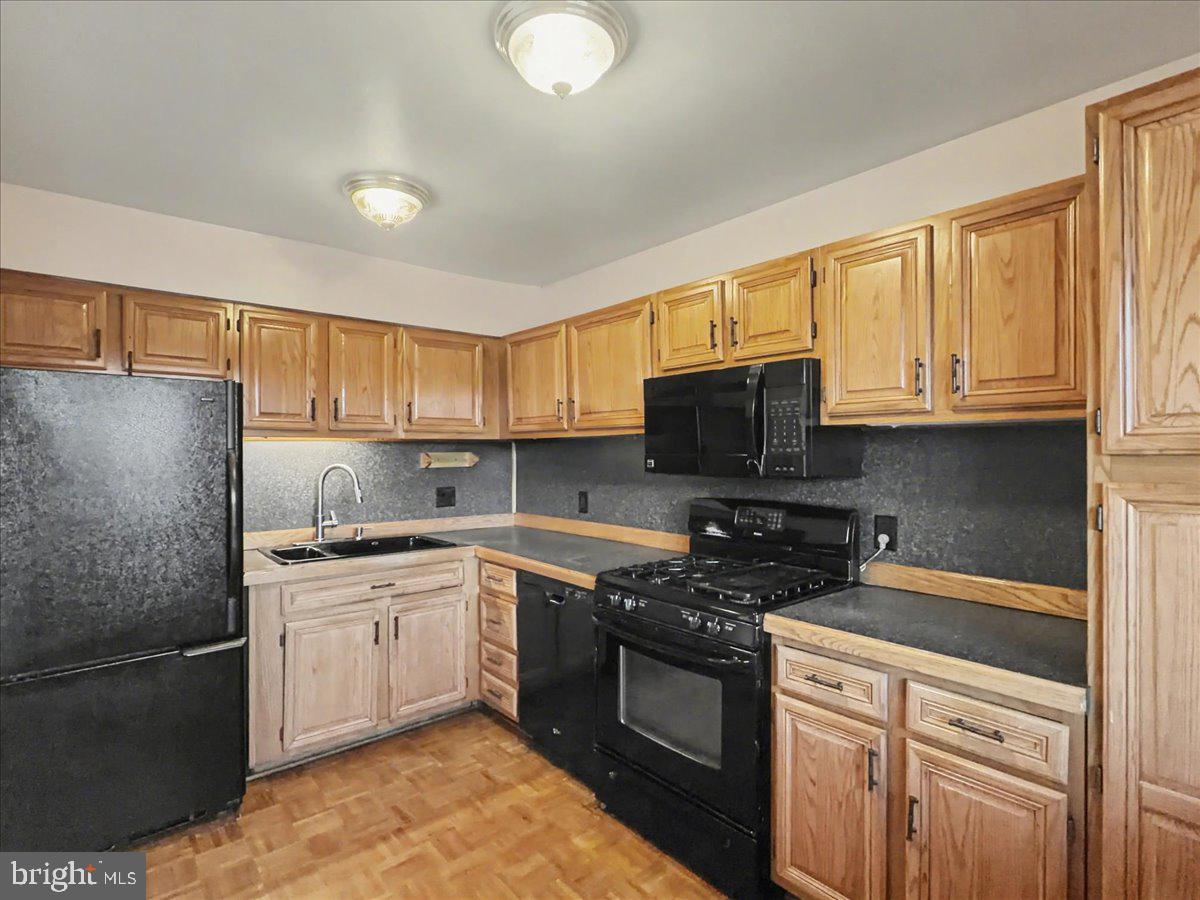 1575 Creekside Road, Unit A21 Whitehall, PA 18052 - Photo 9 of 21 a kitchen with a sink stove and microwave