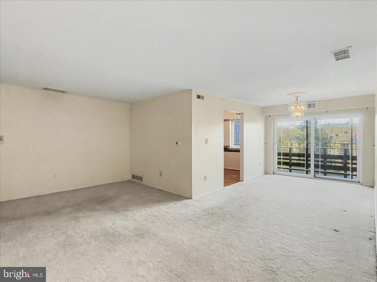 1575 Creekside Road, Unit A21 Whitehall, PA 18052 - Photo 10 of 21 an empty room with large windows and sliding door