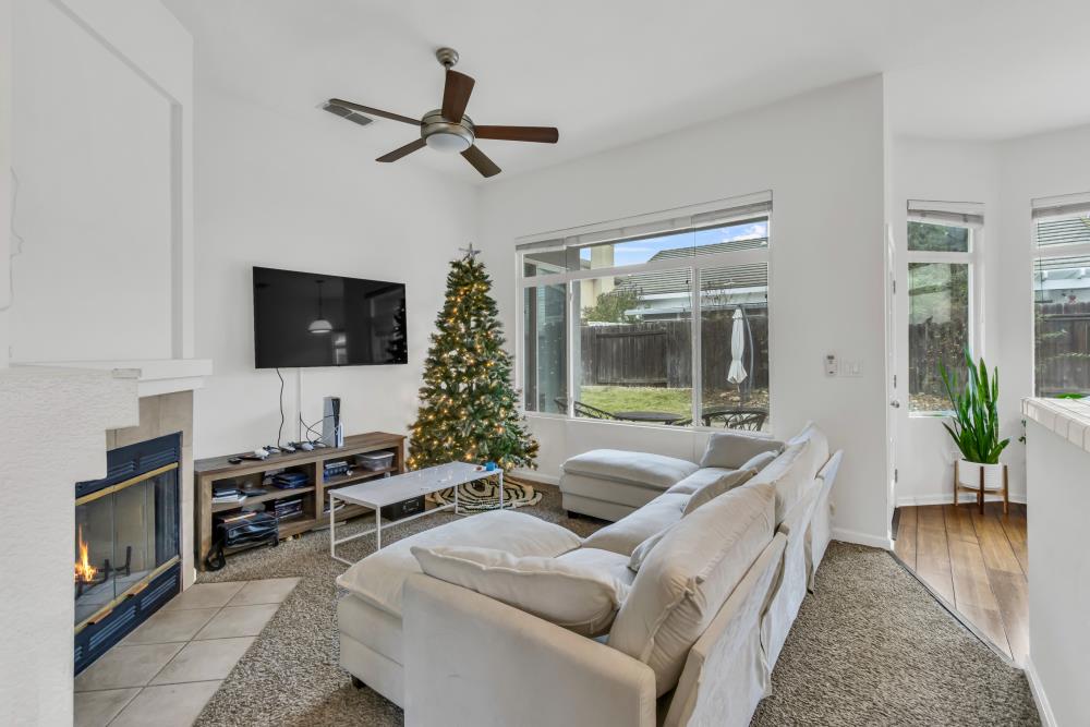 8679 Spring House Way Elk Grove, CA 95624 - Photo 11 of 48 a living room with furniture and a flat screen tv