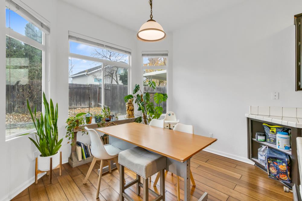 8679 Spring House Way Elk Grove, CA 95624 - Photo 15 of 48 a view of a dining room with furniture window and wooden floor