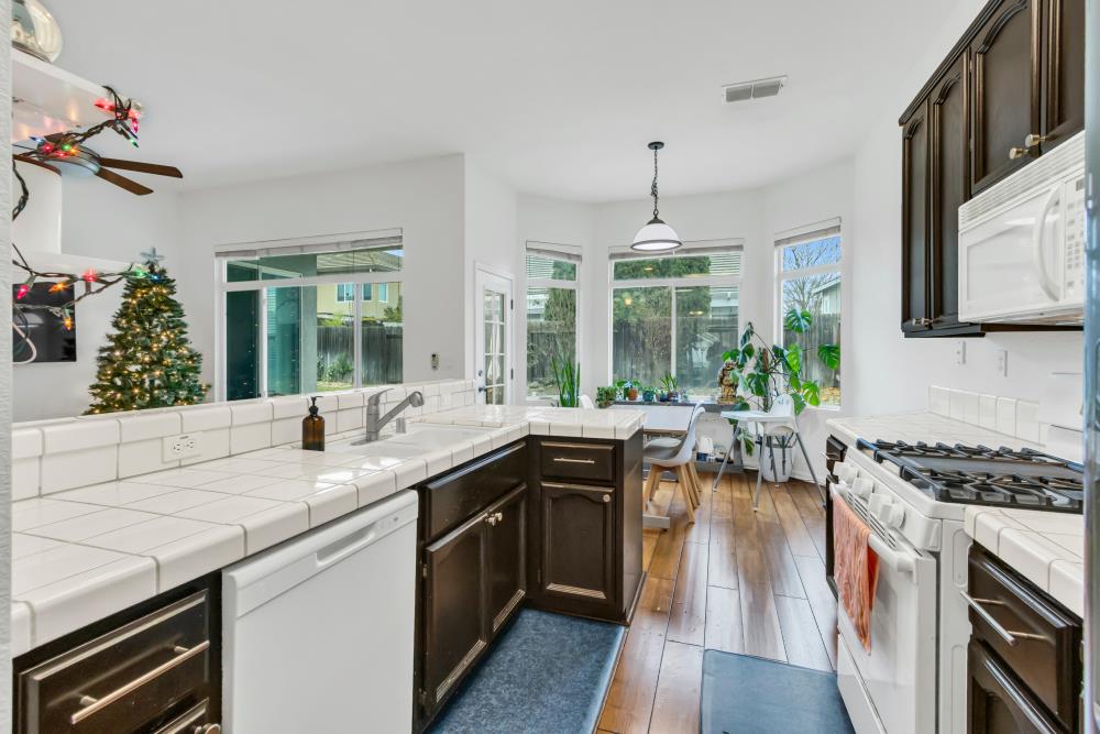 8679 Spring House Way Elk Grove, CA 95624 - Photo 21 of 48 a kitchen with sink stove and cabinets
