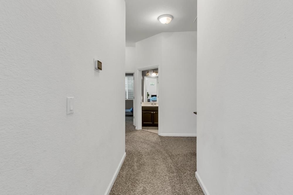 8679 Spring House Way Elk Grove, CA 95624 - Photo 23 of 48 a view of a hallway with an empty room