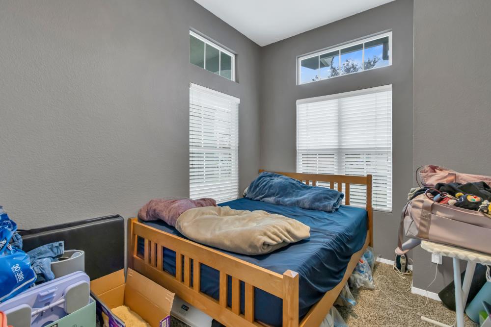 8679 Spring House Way Elk Grove, CA 95624 - Photo 25 of 48 a bedroom with furniture and a window