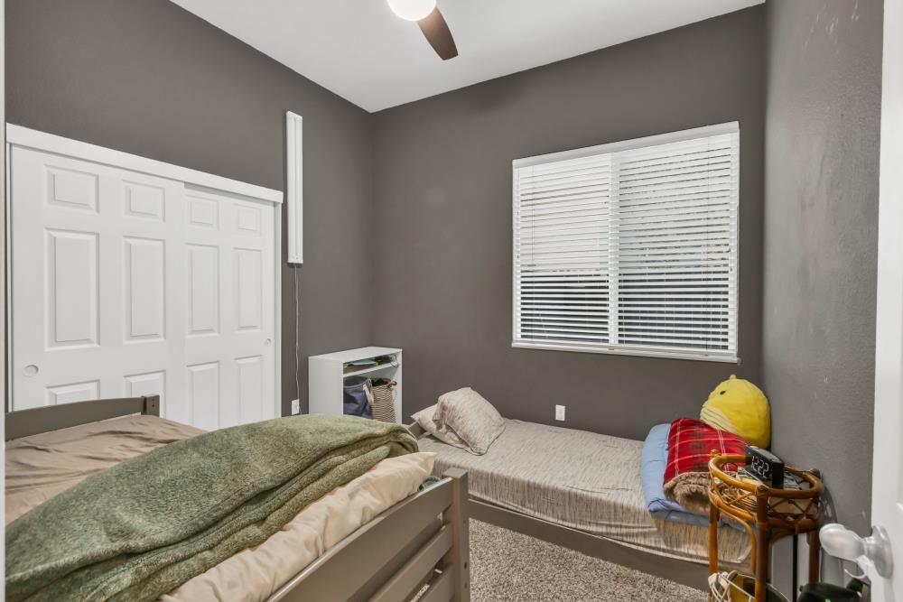 8679 Spring House Way Elk Grove, CA 95624 - Photo 26 of 48 a bedroom with a bed and a window