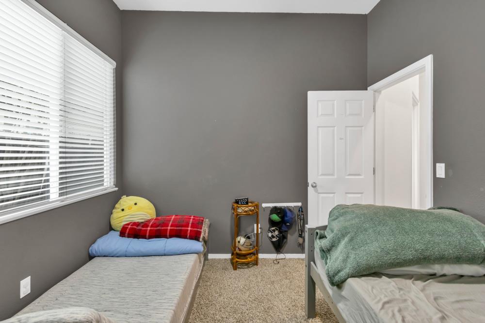 8679 Spring House Way Elk Grove, CA 95624 - Photo 27 of 48 a bedroom with a bed and a window