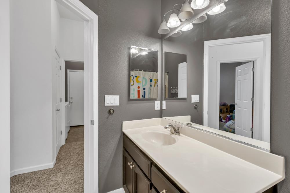 8679 Spring House Way Elk Grove, CA 95624 - Photo 30 of 48 a bathroom with a sink and a mirror