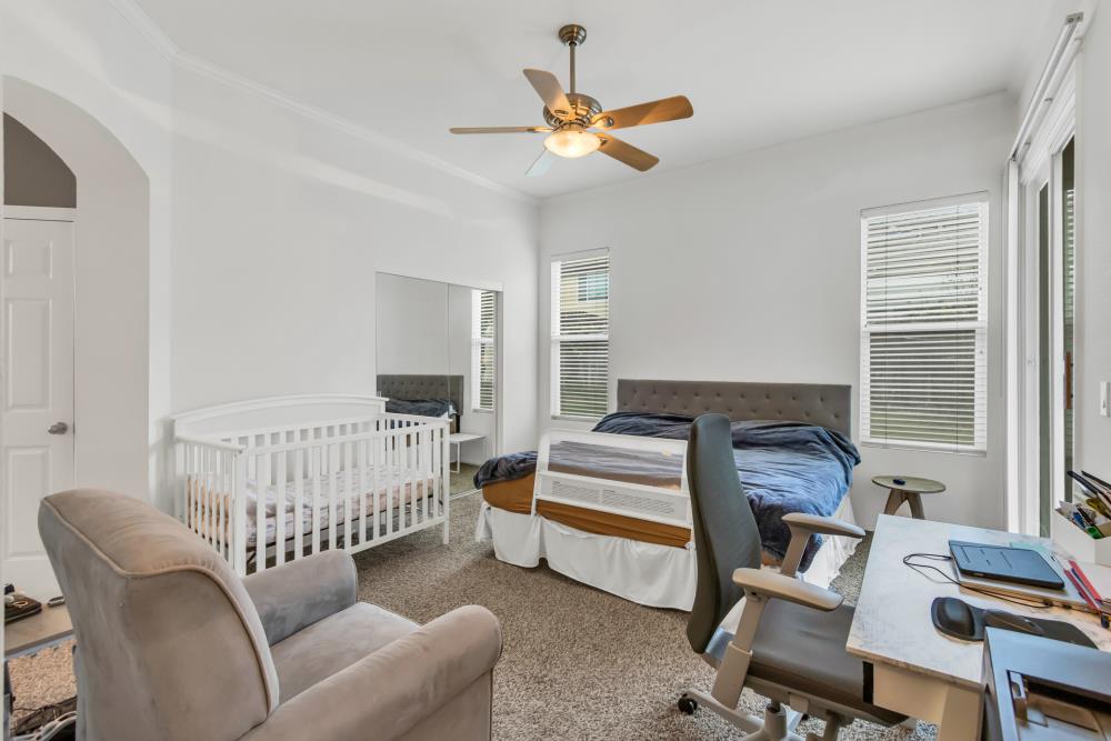 8679 Spring House Way Elk Grove, CA 95624 - Photo 31 of 48 a living room with furniture a ceiling fan and a window
