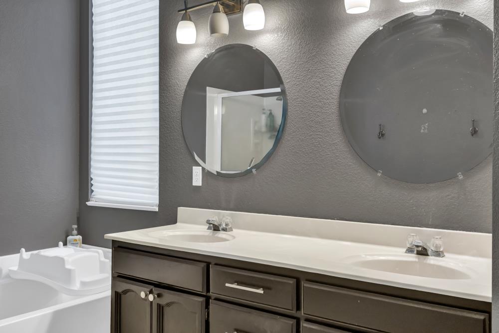 8679 Spring House Way Elk Grove, CA 95624 - Photo 34 of 48 a bathroom with a double vanity sink and a mirror