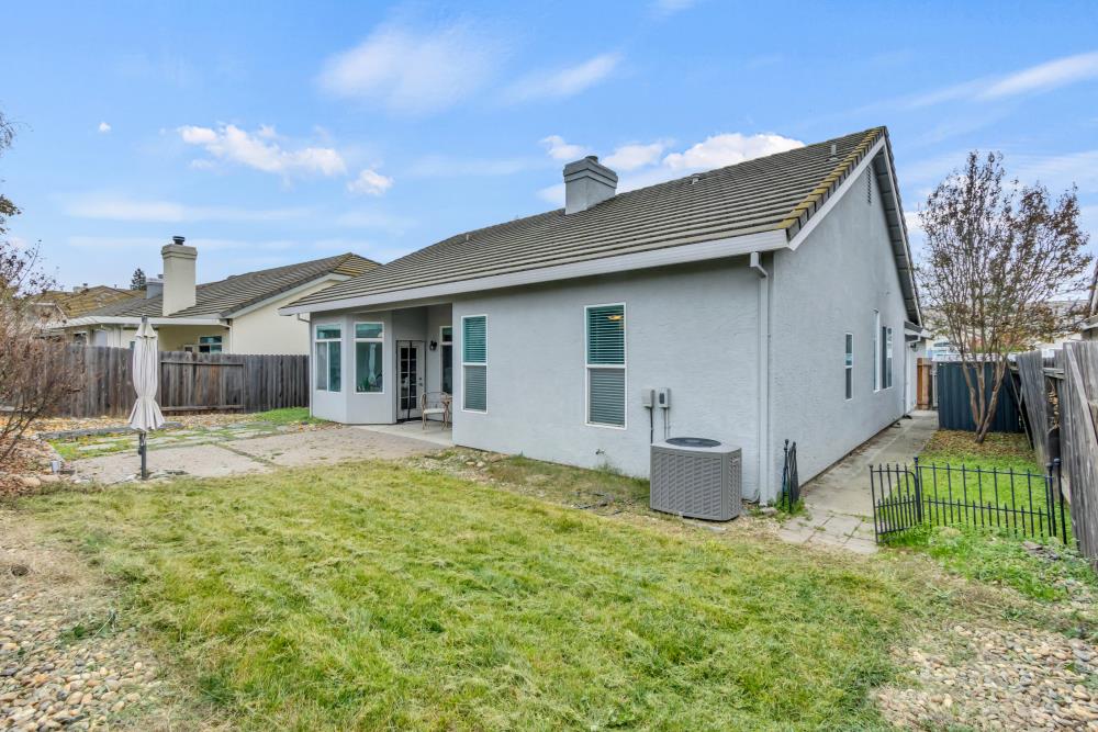 8679 Spring House Way Elk Grove, CA 95624 - Photo 37 of 48 a house that has a big yard and large trees