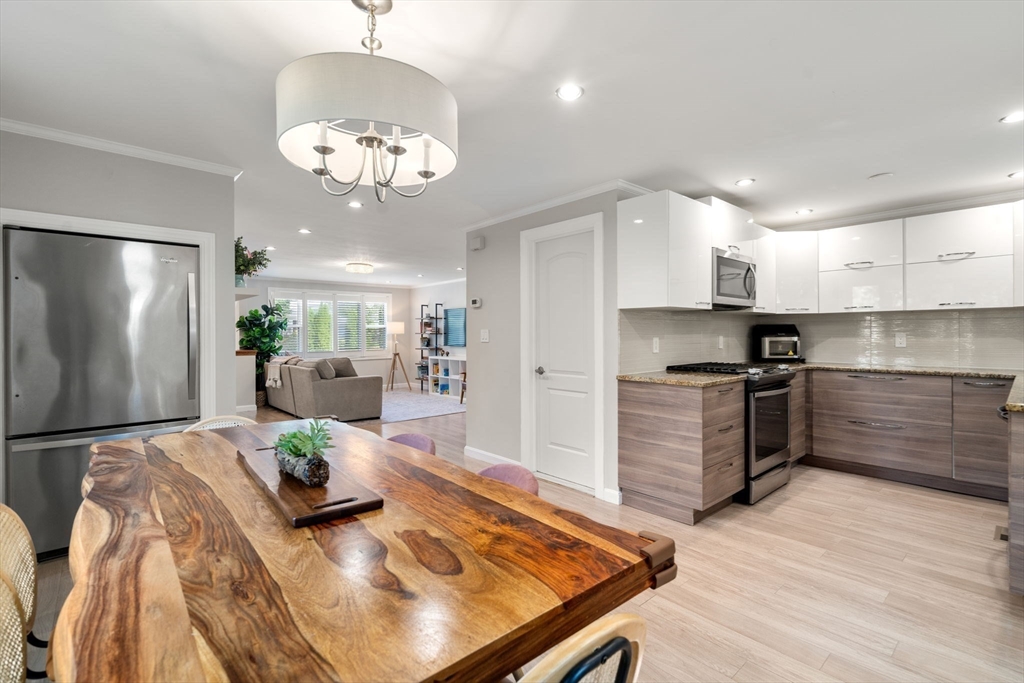 149 Bolivar Street, Unit C6 Canton, MA 02021 - Photo 2 of 41 a kitchen with kitchen island stainless steel appliances a stove refrigerator and cabinets
