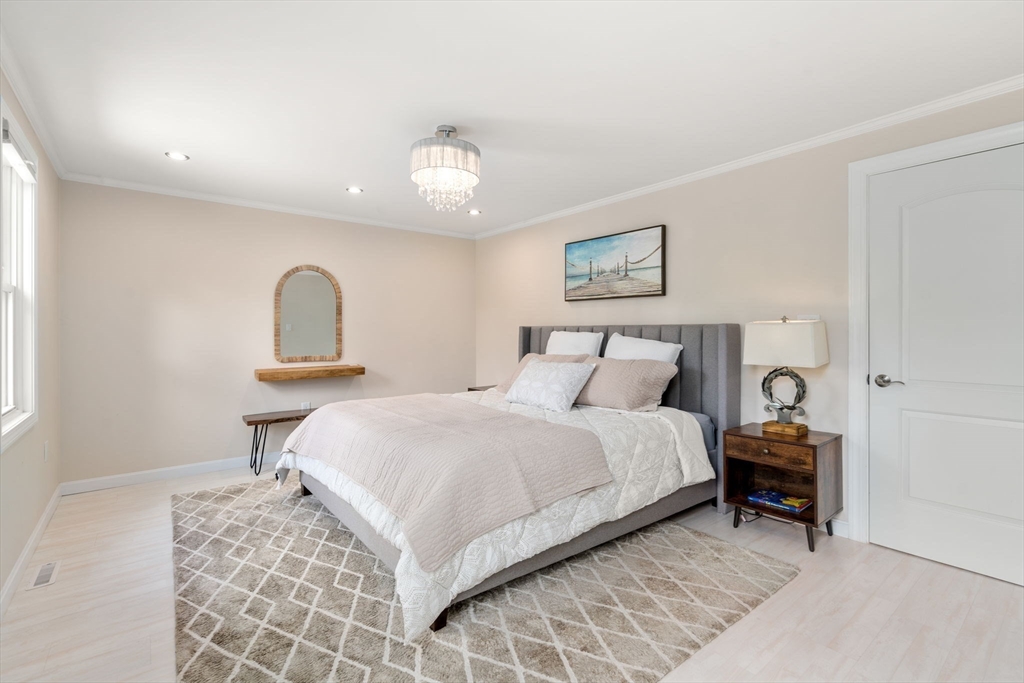 149 Bolivar Street, Unit C6 Canton, MA 02021 - Photo 23 of 41 a bedroom with a bed and a lamp on table