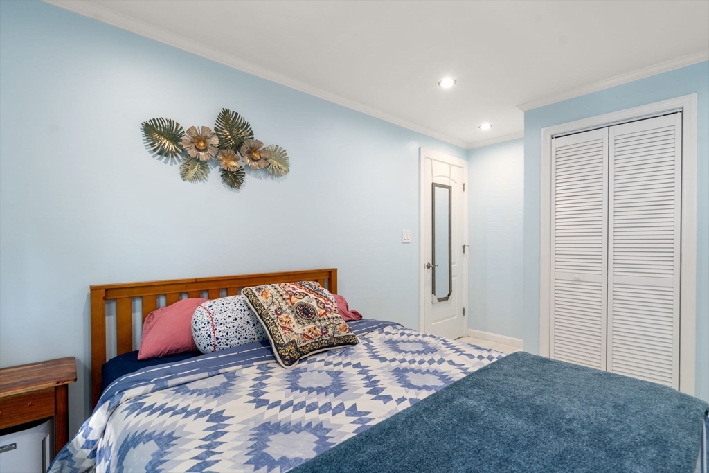 149 Bolivar Street, Unit C6 Canton, MA 02021 - Photo 26 of 41 a bedroom with a large bed and a chandelier