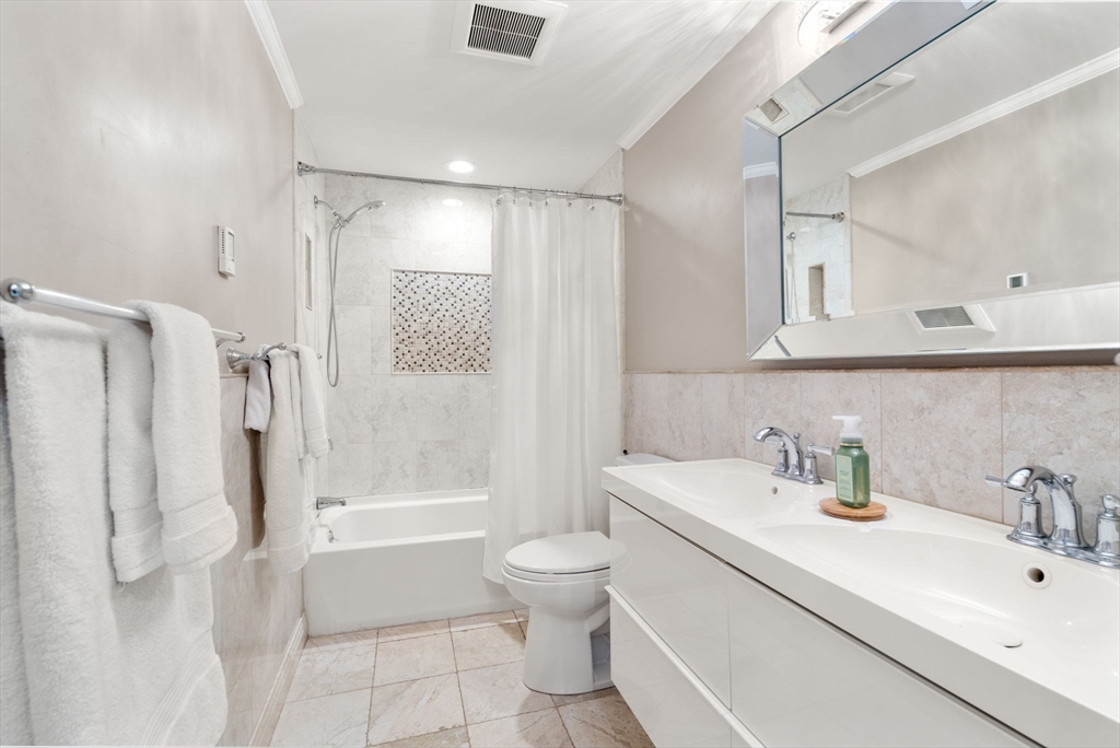 149 Bolivar Street, Unit C6 Canton, MA 02021 - Photo 28 of 41 a bathroom with a sink a toilet and a large mirror