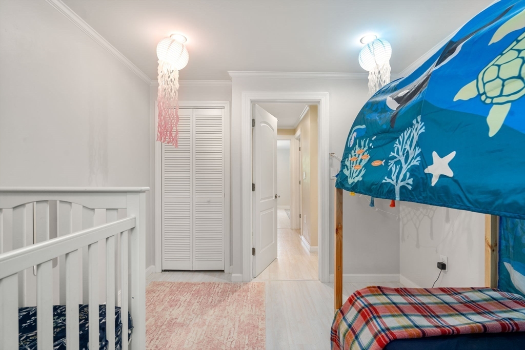 149 Bolivar Street, Unit C6 Canton, MA 02021 - Photo 30 of 41 a bedroom with a bed and a painting on the wall