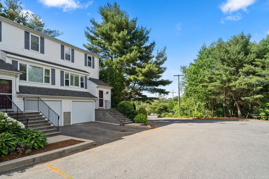 149 Bolivar Street, Unit C6 Canton, MA 02021 - Photo 37 of 41 a front view of a house with a yard and a garage