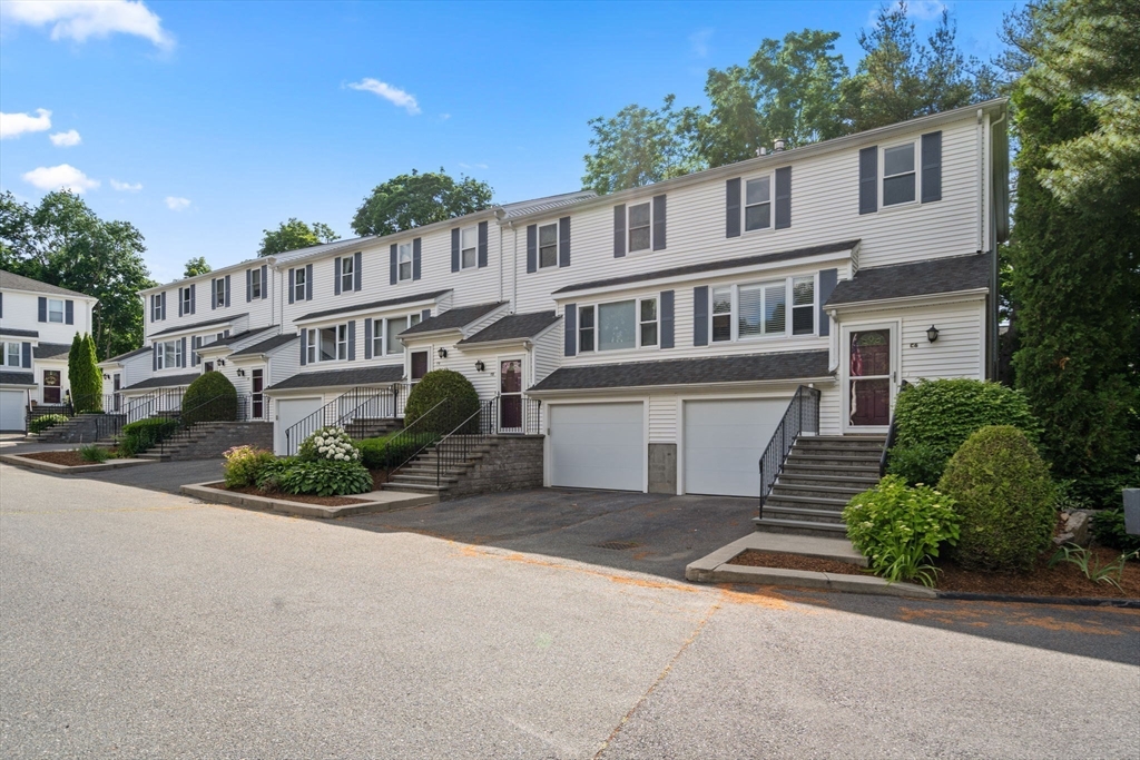 149 Bolivar Street, Unit C6 Canton, MA 02021 - Photo 39 of 41 a front view of a house with a yard and garage