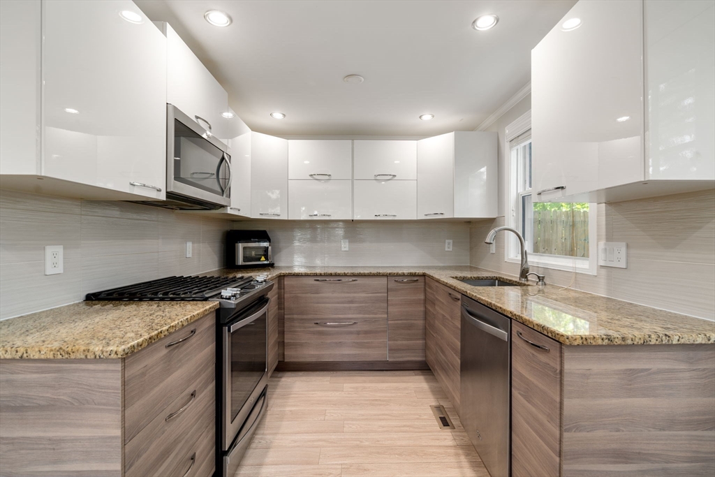149 Bolivar Street, Unit C6 Canton, MA 02021 - Photo 7 of 41 a kitchen with a stove sink and cabinets